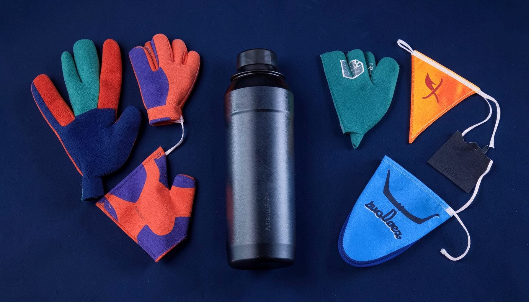 Sports accessories including foam fingers, water bottles, and pennants on a navy background